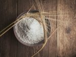 Flour and wheat on a wooden background. flat lay.